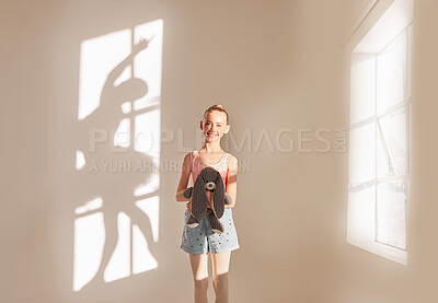 Buy stock photo Creative art and dance with a girl dreaming of ballet with motivation and goal of becoming dancer in a studio with a teddy bear. Shadow of a ballerina or dancer on a wall with a kid next to a window