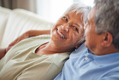 Buy stock photo Happy, love and smile senior couple hugging relax and sitting on a couch at home. Man and woman lovers smiling and enjoying quality bonding together in the living room and having fun in the house