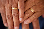 Support, trust and love of a senior married couple hands with rings and are in love for many years. Closeup of mature lovers touching and showing feelings of compassion and care