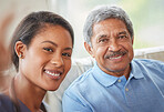 Portrait senior man and woman nurse with a selfie in the living room of a retirement home. Healthcare worker and elderly male smile while bonding on a couch together at a house for retired people