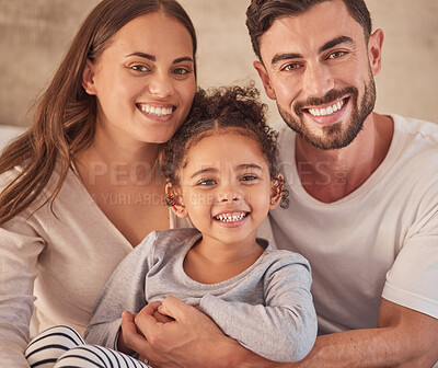 Buy stock photo Happy family, girl and an interracial couple smiling and excited about spending quality time together. Portrait of parents, mother and father having fun with their adopted daughter at home