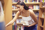 College student in library for books, education and university study learning. Young nerd woman at reading bookshelf in bookstore shopping, studying and story choice for project, knowledge and exam