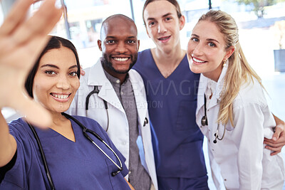 Buy stock photo Team of doctors take a selfie together after success in the surgery emergency room in a hospital office. Happy, teamwork and young healthcare workers ready to help people with medical treatment