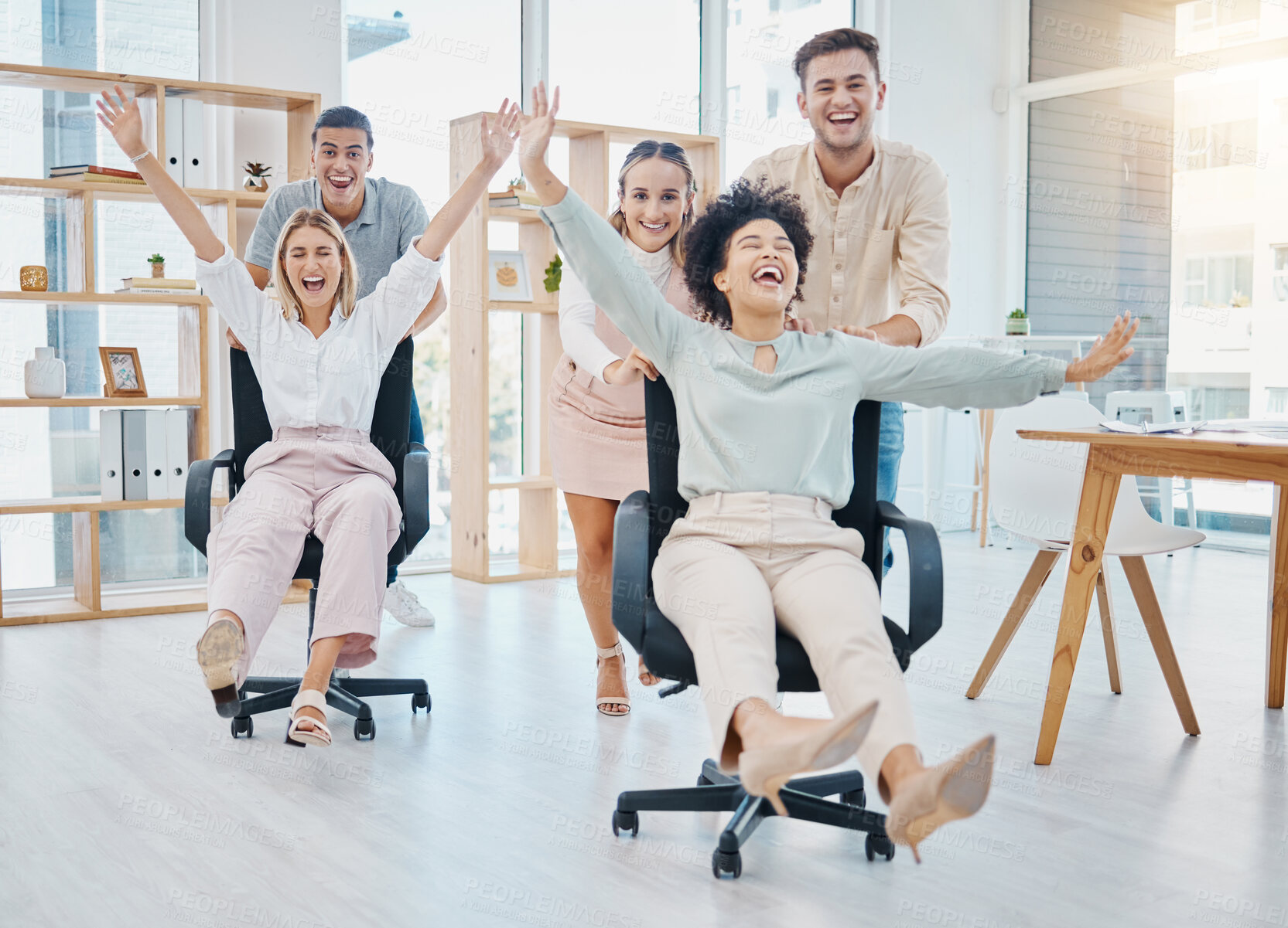 Buy stock photo Happy business people doing office games with chair at work, celebration of success and freedom at startup company and crazy teamwork at job. Comic, smile and funny team doing teambuilding together