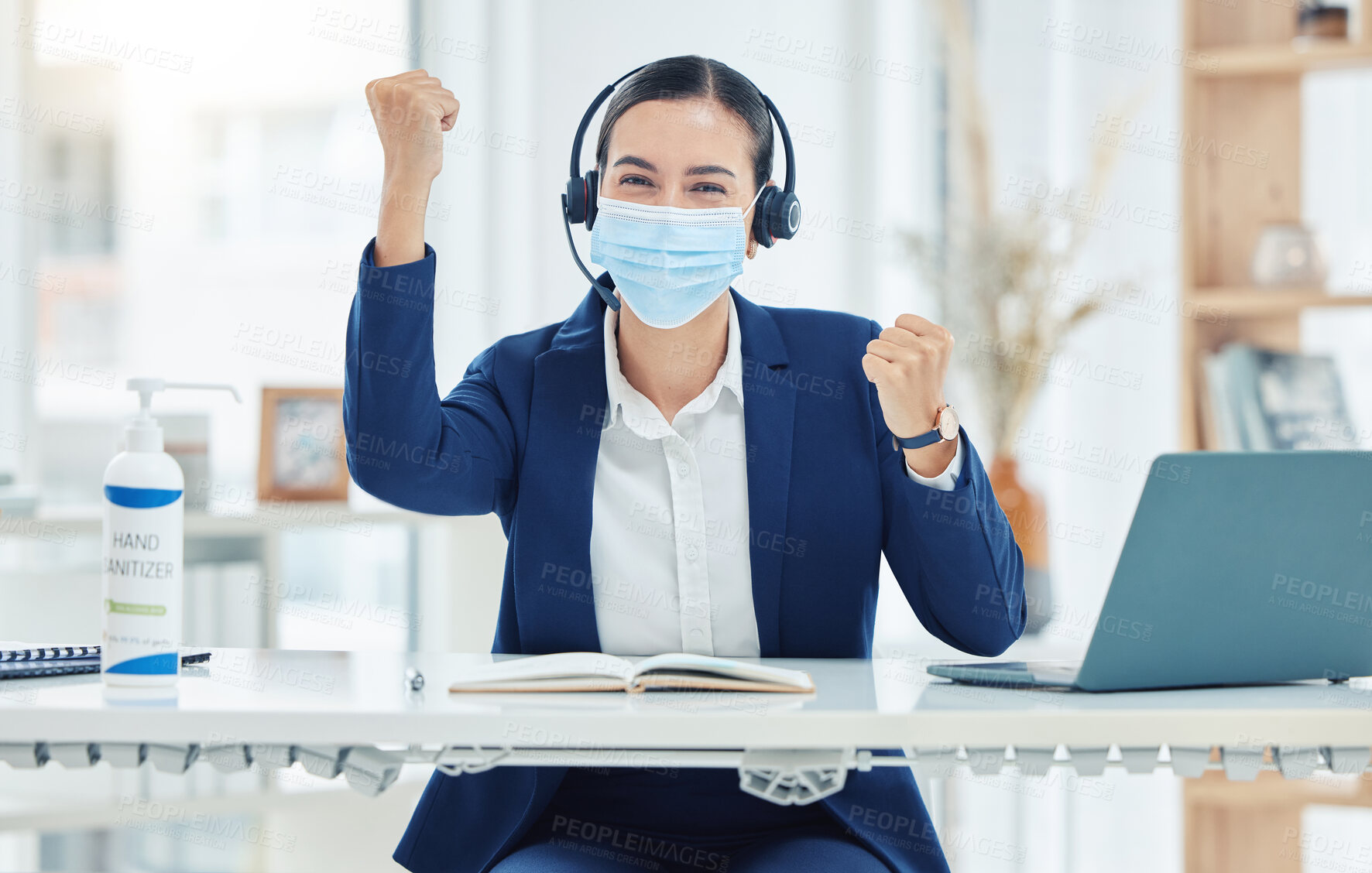 Buy stock photo Customer service, call center and telemarketing agent celebration while wearing mask and headset working on a laptop alone at work. Business woman cheering for sale success at a desk in an office