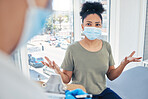 Covid, healthcare and patient in a hospital with a doctor looking frustrated at a delay during a medical appointment for consulting and advice. Woman in a mask feeling upset during an appointment