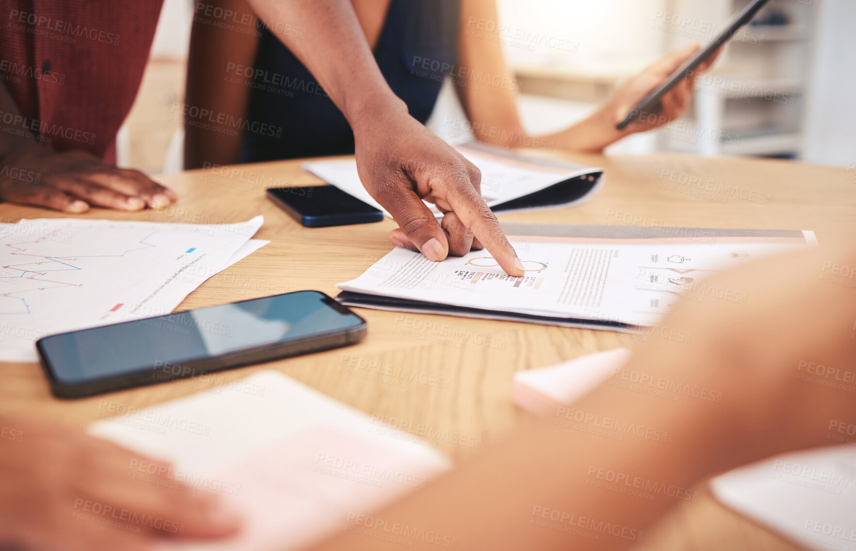 Buy stock photo Hands of advertising or marketing planning team working on strategy on a table in a startup office. Corporate workers read graph data documents to research popular market trends in business meeting