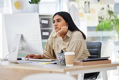 Buy stock photo A bored, lazy and tired employee working on a computer in the office leaning on her desk. An overworked business woman is annoyed and frustrated by her job sitting at her table feeling burnout