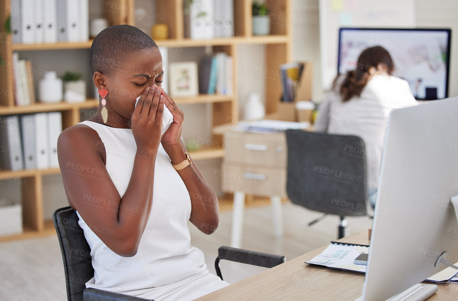 Buy stock photo Sick corporate employee suffering with the flu, cold or covid while working in an office. Young professional with sinus or allergy, sneezing and feeling ill at work, blowing nose and uncomfortable