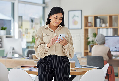 Buy stock photo Entrepreneur on phone with social media online in a modern office. Business woman smile while chatting and checking email at work or sharing good news of a successful startup with a mobile smartphone