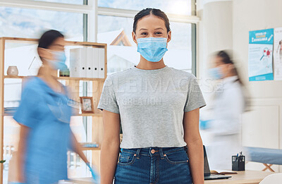 Buy stock photo Covid, mask and medicine with a woman in the hospital and a doctor and nurse in the background for consulting, healthcare and wellness. Medical, trust and help with a female patient in a clinic