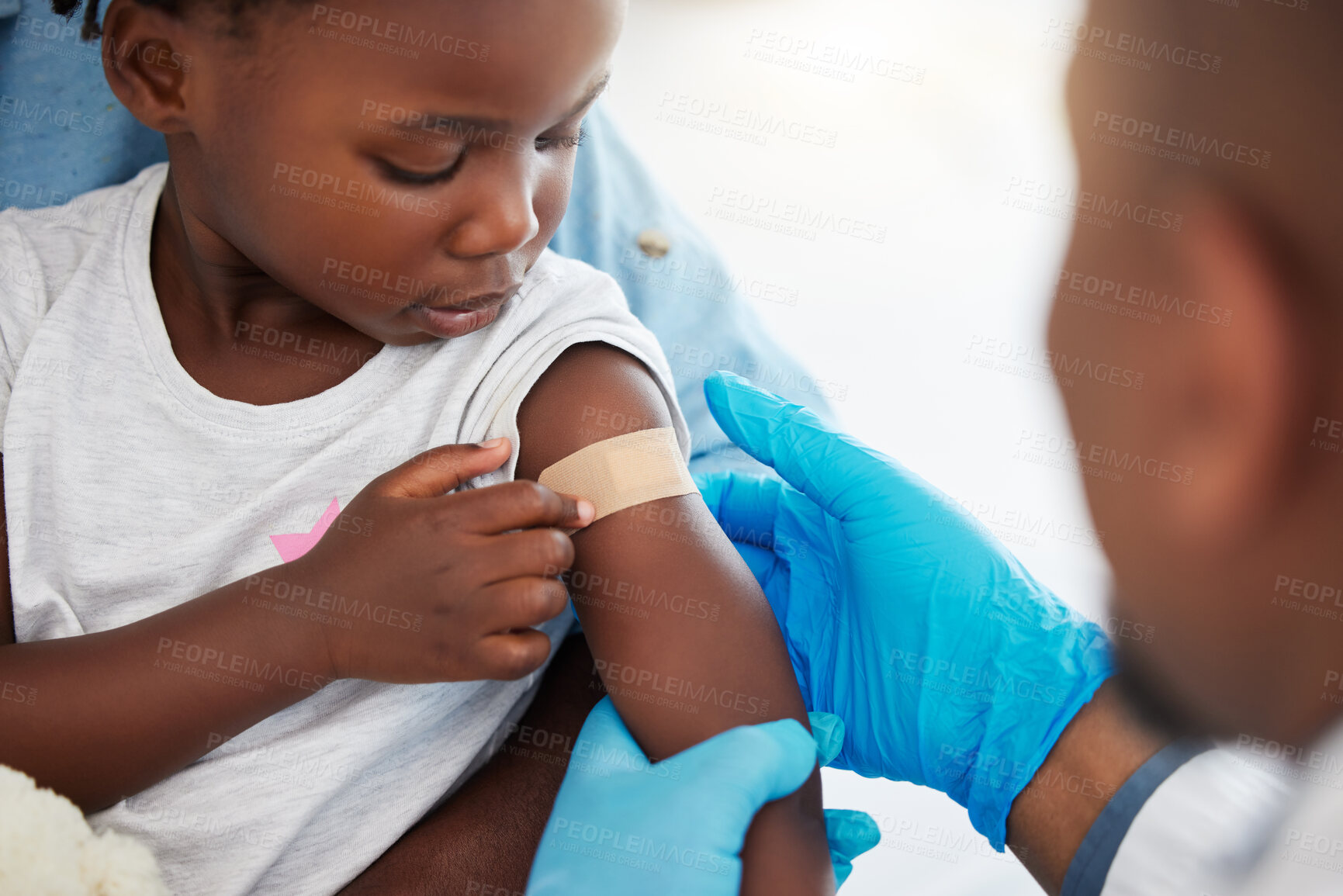 Buy stock photo Doctor, healthcare expert and medical worker with plaster on arm of sick child after covid vaccine, help with medical emergency and consulting with patient at hospital. Girl with bandage after injury