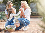 Mother, child and garden plant smelling together with family in a beautiful and green landscape. Motherhood, happiness and bonding in stunning nature with young kid holding fresh picking.