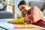 Woman, wipe table and spray with cloth, for hygiene and disinfectant in home. Cleaner, maid or female cleaning service for bacteria, dust on furniture and housekeeping with rag, surface and detergent