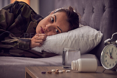 Buy stock photo Depressed woman, bed and medicine for insomnia, mental health and anxiety of military soldier with stress, depression and trauma. Army female in bedroom with ptsd, pills and thinking about drugs