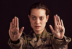 Soldier portrait and stop hands for war protest of asian woman with political palm statement. Serious, unhappy and army girl frustrated with violence in Ukraine with black studio background.

