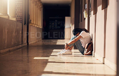 Buy stock photo Sad, lonely and girl with depression at school, crying and anxiety after bullying. Mental health, tired and unhappy student in the corridor after problem in class, education fail and social isolation