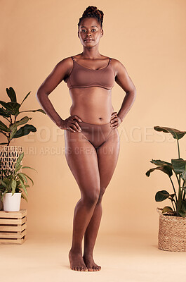 Buy stock photo Portrait, body and beauty with a model black woman in studio on a beige background with hands on hips. Health, wellness and underwear with an attractive young plus size female posing for natural care