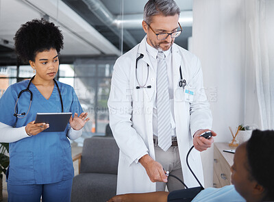 Buy stock photo Doctor, patient and blood pressure in clinic with nurse, tablet and analysis for teamwork, health or job. Healthcare expert, medical support and tech for consulting, help or wellness advice in Cuba
