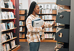 Books, education or black woman in a library to search for knowledge by bookshelf on a school or college campus. Focused, studying or university student learning for a scholarship or better future