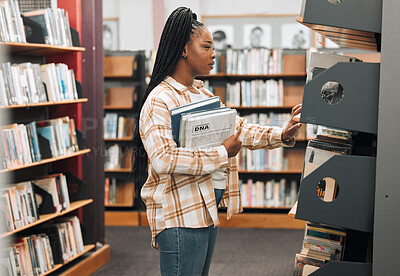 Buy stock photo Books, education or black woman in a library to search for knowledge by bookshelf on a school or college campus. Focused, studying or university student learning for a scholarship or better future