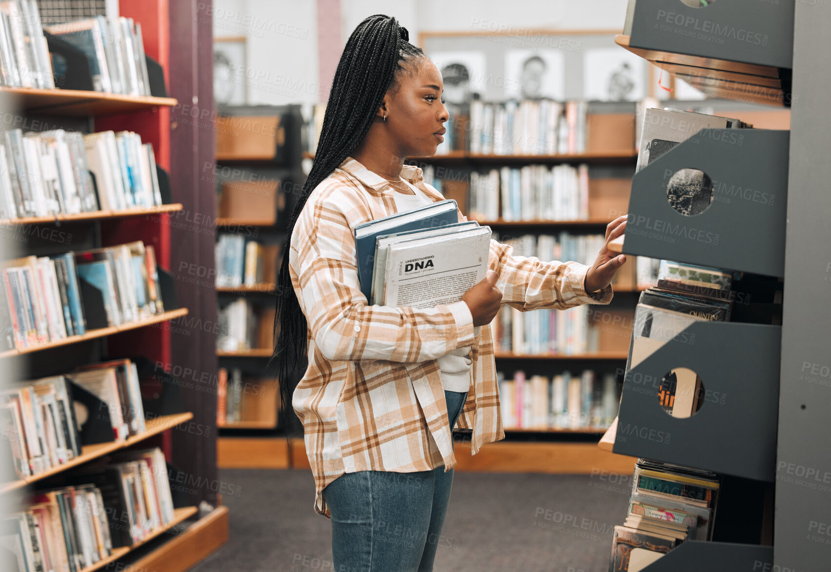 Buy stock photo Books, education or black woman in a library to search for knowledge by bookshelf on a school or college campus. Focused, studying or university student learning for a scholarship or better future