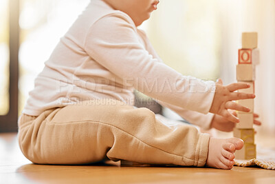 Buy stock photo Shot of a unrecognizable baby playing with blocks at home