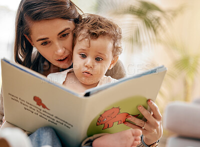 Buy stock photo Shot of a mother reading a book to her son at home