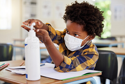 Buy stock photo Student applying sanitizer in school class for hygiene, clean hands and to protect from spread of covid and cold germ. Afro child or little boy learning and getting education in corona virus pandemic