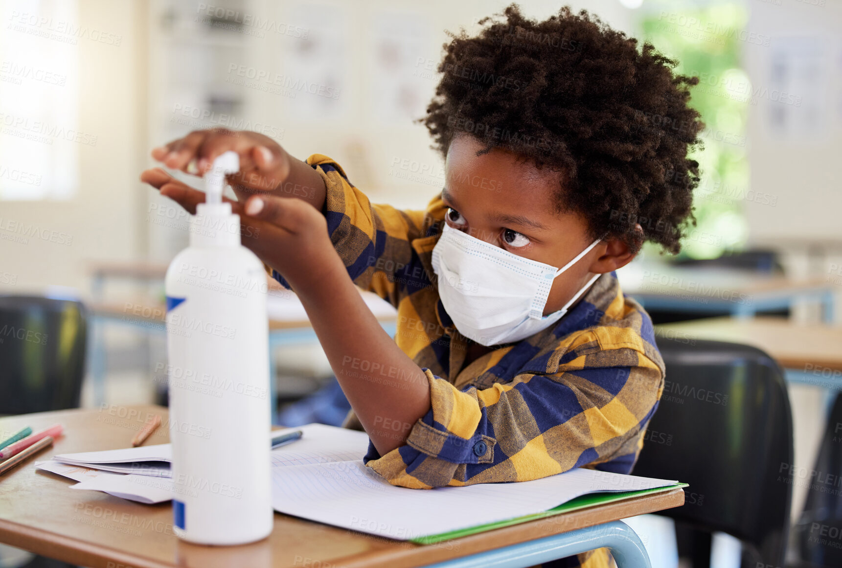 Buy stock photo Student applying sanitizer in school class for hygiene, clean hands and to protect from spread of covid and cold germ. Afro child or little boy learning and getting education in corona virus pandemic