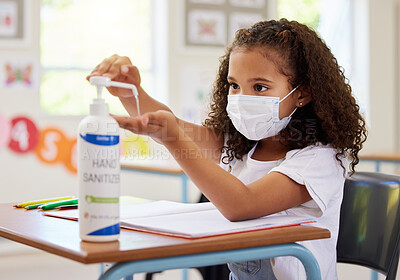 Buy stock photo School kid using hand sanitizer for germ protection, hygiene and disinfection during covid protocol regulations in a classroom. Young student cleaning hands for safety of flu, corona and virus