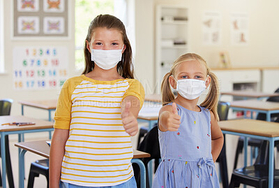 Buy stock photo School kids, thumbs up and healthy students wearing masks in a classroom protecting against covid. Portrait of cute, young and friendly girls in a safe learning and educational environment together
