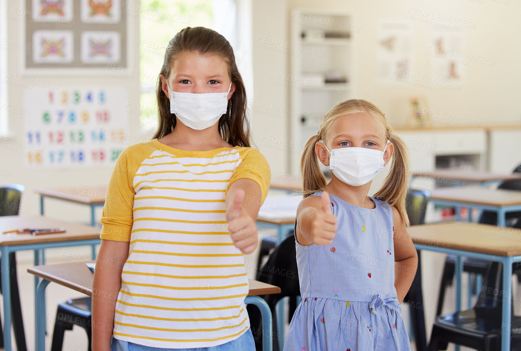 Buy stock photo School kids, thumbs up and healthy students wearing masks in a classroom protecting against covid. Portrait of cute, young and friendly girls in a safe learning and educational environment together