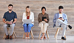 Business people waiting at interview for work in a line, networking on tablet, cellphone and planning sitting in line in an office together. Corporate employee, worker and professional at job center 
