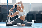 Fitness, exercise and workout with a woman stretching, warming up and training in a gym for heath, wellness and warmup. Young female athlete getting ready for a working out session in a sports club