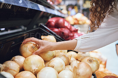 Vegetables, grocery shopping and health while a customer choose fresh onions in supermarket or greengrocer store. Close up hands of woman buying vegan food groceries before inflation at retail market