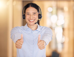 Thumbs up for success, success at call center company and hand sign for achievement in telemarketing industry at work. Portrait of a customer support worker helping, in agreement and support in sales