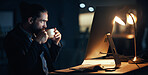 Coffee, night and commitment with a business man working late in a dark office on a deadline. Male corporate professional at work on a computer at his desk for a global or international project