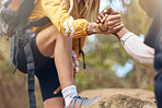 Hands, hiking friends and help from men in environment, forest nature and countryside fitness. Zoom on support people on a relax workout, training or climbing exercise on rock for health and wellness