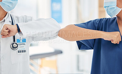 Buy stock photo Doctor and nurse greeting with elbow to stop covid spread in a hospital while collaboration, thank you or welcome. Healthcare teamwork, support and support in a medical facility with mask for safety 