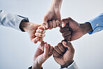 Teamwork, motivation and collaboration fist bump hands gesture, sign or icon below on studio wall background mockup. Diversity worker group or business people together in unity, solidarity and effort