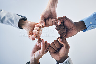 Buy stock photo Teamwork, motivation and collaboration fist bump hands gesture, sign or icon below on studio wall background mockup. Diversity worker group or business people together in unity, solidarity and effort
