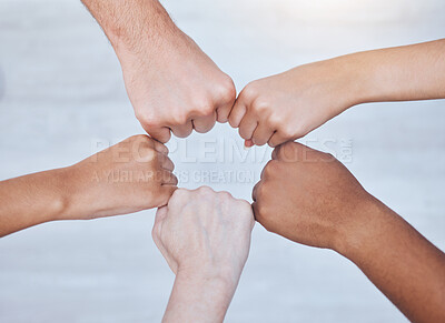 Buy stock photo Fist bump, unity and support group touching hands in a circle at a community therapy session. Top view of friends doing team building, care and trust exercise while bonding at  a fellowship event.