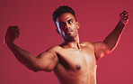 Beauty, body and fitness with a nude man model posing shirtless in studio with a red background. Naked, art and strength with a healthy man standing and flexing arms inside for health and wellness