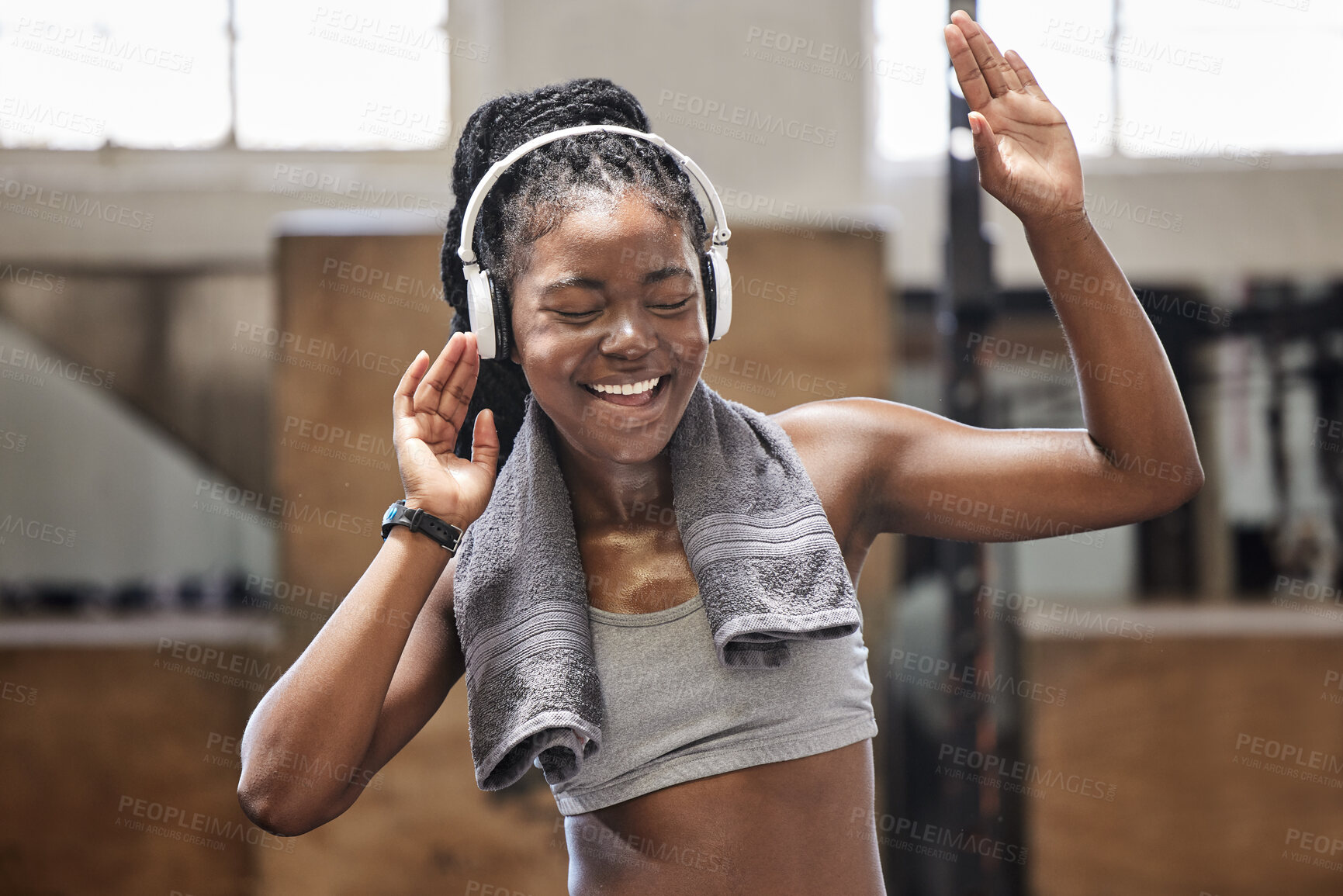 Buy stock photo Happy athlete singing and dance with headphone in a gym after fitness, exercise and training. Cheerful woman sweating having fun with music after health and wellness cardio workout in a sports club