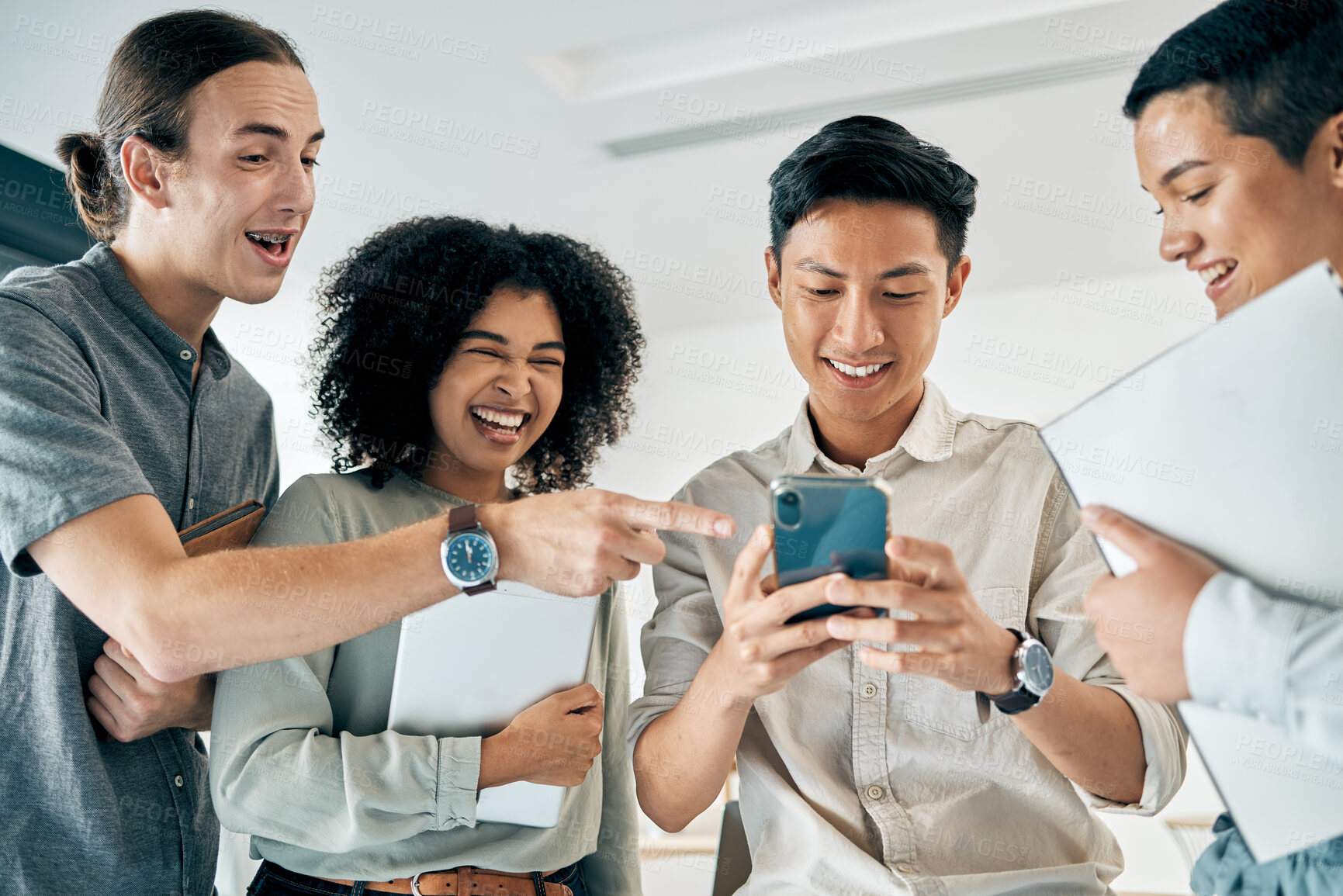 Buy stock photo Diversity, startup and a happy team of women and men on a phone, after meeting and laughing at social media. Teamwork, motivation and tech for office employees. Happy friends or students having fun
