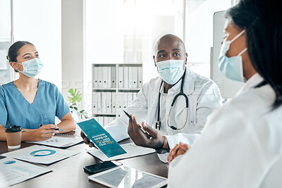 Buy stock photo Team of doctors with face mask consulting on covid results with paperwork and a digital tablet. Healthcare workers in a meeting to discuss the vaccine, treatment and medicine in a hospital office.