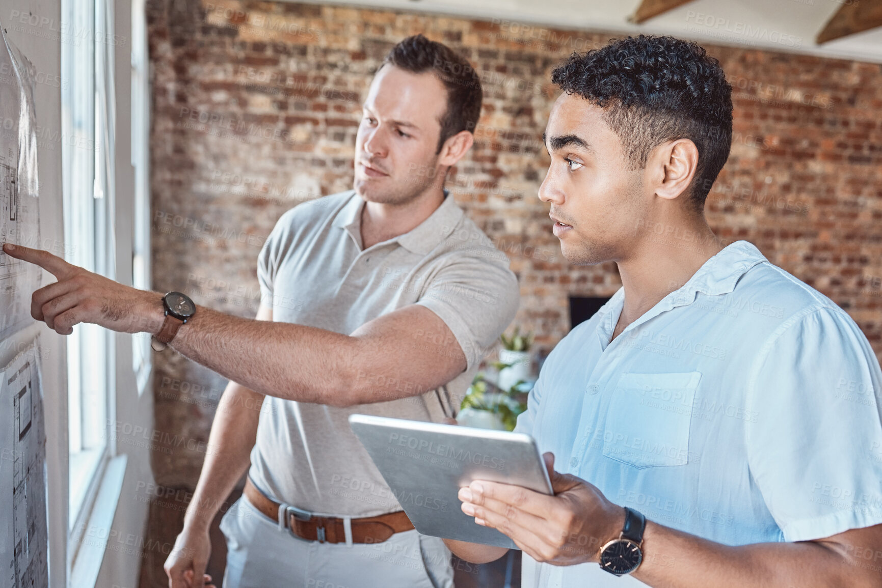 Buy stock photo Teamwork, strategy and architects working on a tablet and planning a floor, building or house plan. Architecture, design and workers or engineers brainstorming together on the wall with documents.