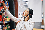 Happy supermarket, grocery shopping and customer with 5g phone, smile and in retail store for food, groceries or product from shelf. Woman with smartphone, communication of sale and on call in shop