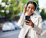 Happy city girl with phone and headphones listening to music, podcast or streaming a online subscription service movie. Black woman watching funny web comedy, internet meme or social media app video 
